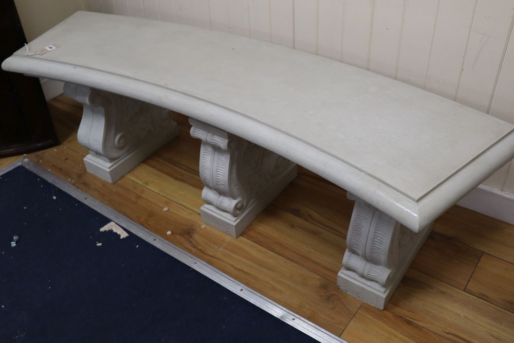 A reconstituted marble concave garden bench, width 150cm height 46cm